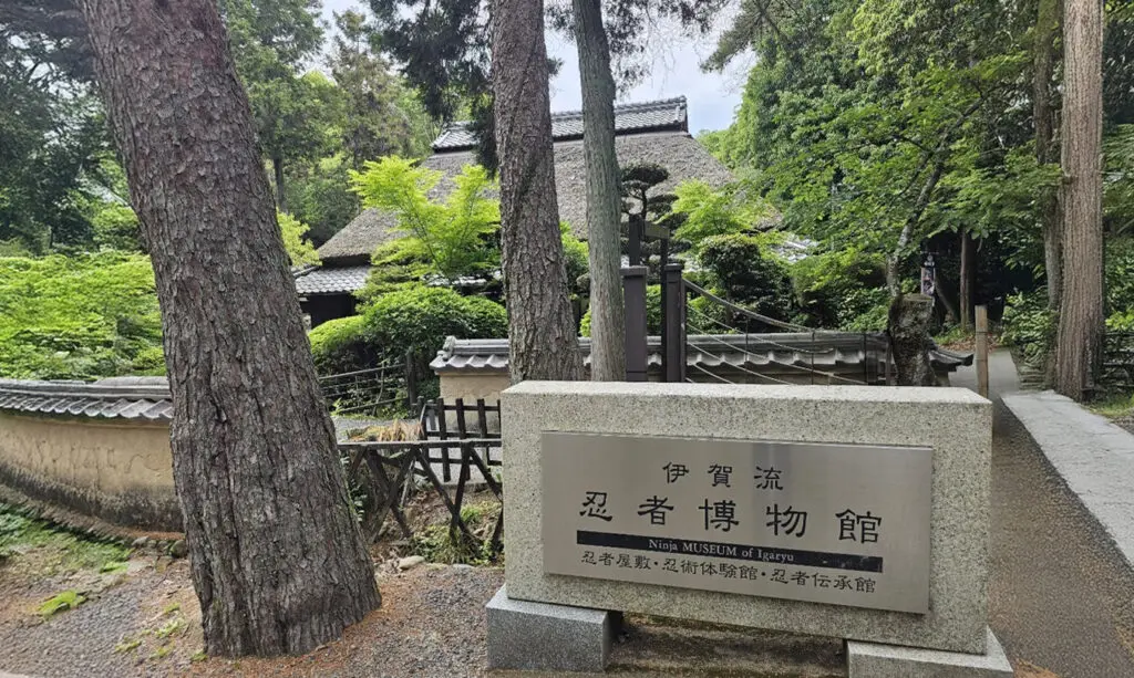 Igaryuninjamuseumentrance | 出産祝い誕生日のプレゼントに家族みんなのパーソナライズ絵本|マイステラ 三重県伊賀市にある伊賀流忍者博物館と、木々に囲まれた茅葺き屋根の建物外観
